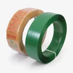 Green PET plastic steel strapping coil beside a wrapped export roll